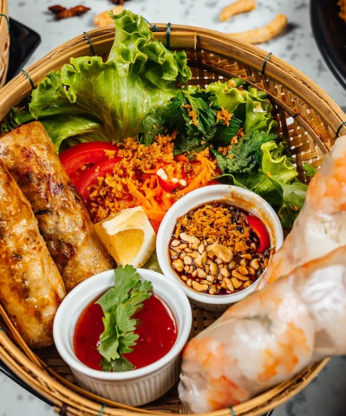 delicious-vietnamese-food-including-pho-ga-noodles-spring-rolls-white-wall_181624-34158